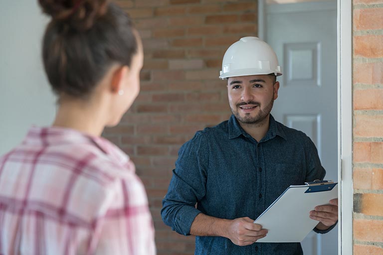 Woman greeting a contractor at the door